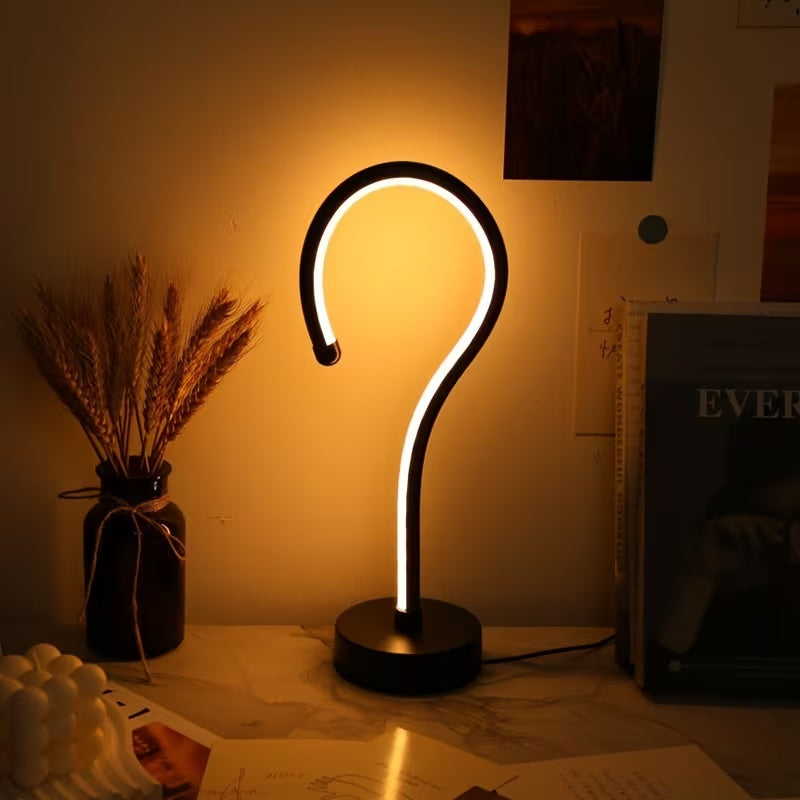 Question Mark Lamp on a marble desk with warm light