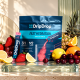DripDrop Juicy Variety pouch and flavor fruit on Zeniqas glass stage